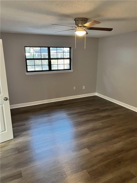 spare room featuring a textured ceiling, ceiling fan, and dark hardwood / wood-style floors