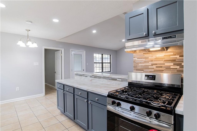 kitchen with tasteful backsplash, light stone counters, stainless steel gas stove, and an inviting chandelier