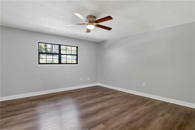 spare room with a textured ceiling, ceiling fan, and dark hardwood / wood-style floors