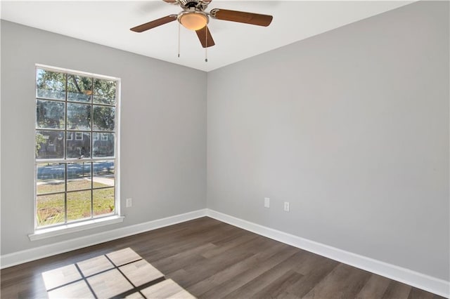 spare room with ceiling fan and dark hardwood / wood-style flooring