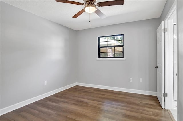 empty room featuring dark hardwood / wood-style floors and ceiling fan