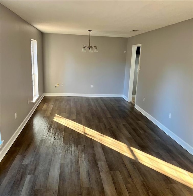 interior space with dark hardwood / wood-style flooring and a chandelier