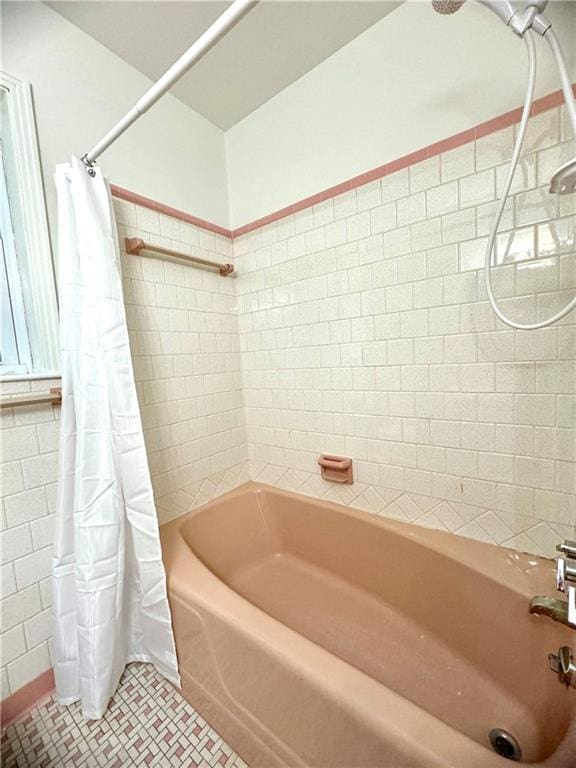 bathroom with shower / bathtub combination with curtain and tile patterned flooring