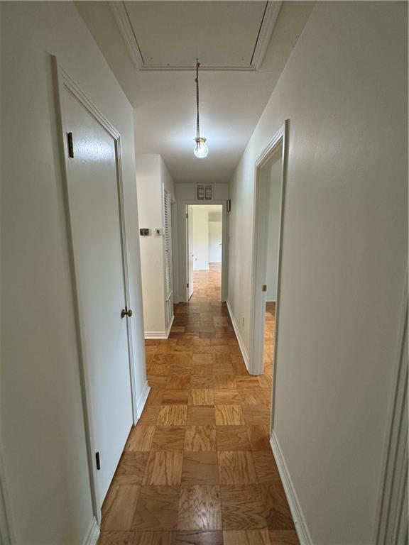 hall with attic access and baseboards