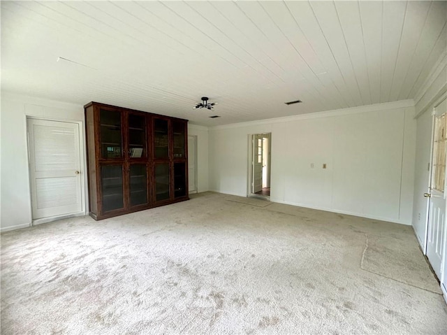 carpeted spare room with crown molding