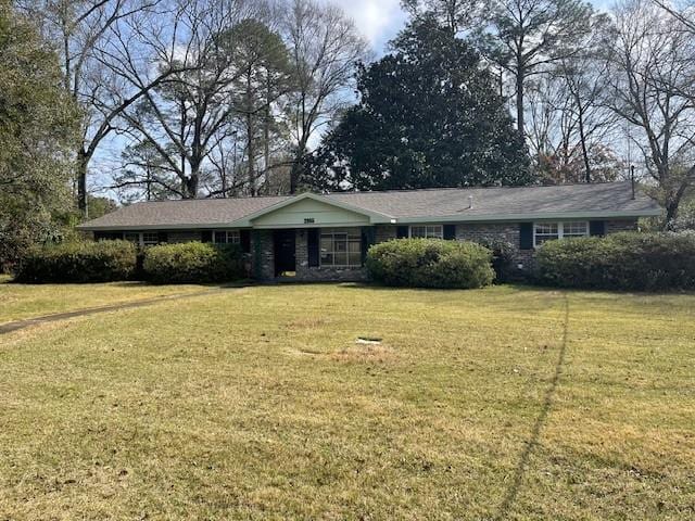 ranch-style home with a front lawn