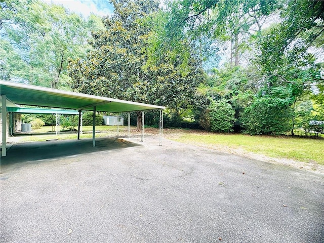 view of parking / parking lot with a carport and aphalt driveway