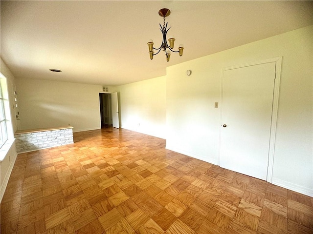 spare room with a chandelier