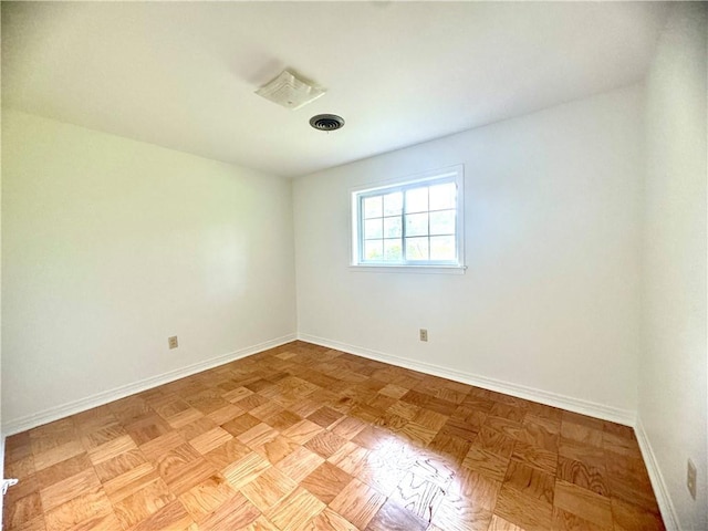 empty room with baseboards and visible vents