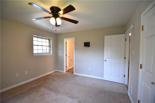 unfurnished bedroom featuring connected bathroom, ceiling fan, and light carpet