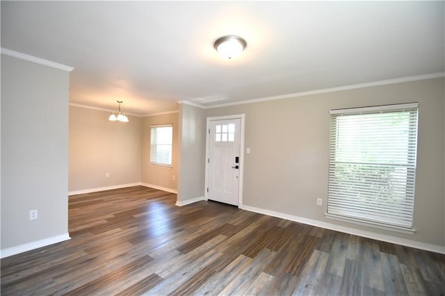 foyer featuring a wealth of natural light, dark hardwood / wood-style flooring, and crown molding