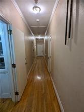 hall featuring hardwood / wood-style flooring and ornamental molding