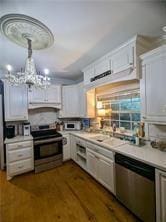 kitchen with sink, an inviting chandelier, dark hardwood / wood-style floors, white cabinets, and appliances with stainless steel finishes