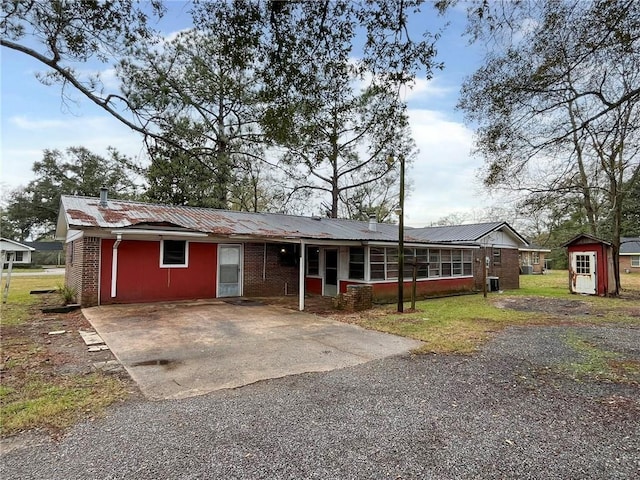 single story home featuring a shed