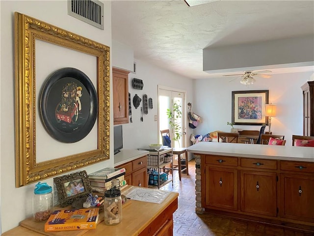 12236 Boulet Dr, Coden, AL 36523 - home office with ceiling fan, a textured ceiling, and brick patterned floors