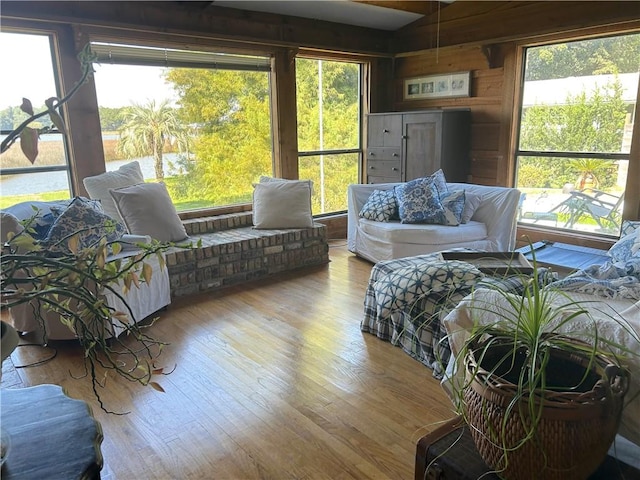 living room with wooden walls and light wood-type flooring