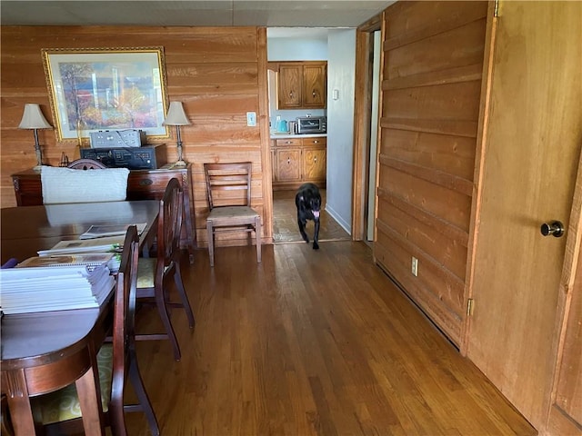 office space with wooden walls and wood-type flooring