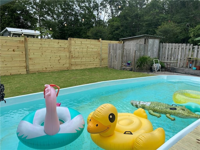 view of swimming pool with a storage unit