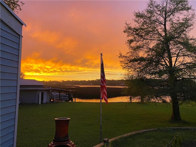 yard at dusk with a water view