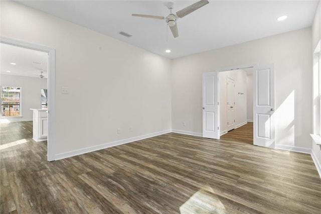 spare room with ceiling fan and dark hardwood / wood-style flooring