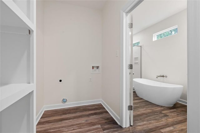 bathroom with a bathing tub and hardwood / wood-style flooring