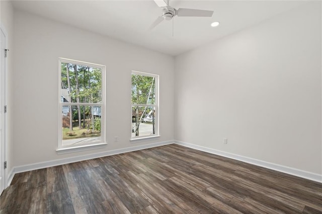 spare room featuring dark wood-type flooring and ceiling fan