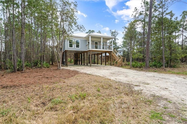 coastal home with a porch and a carport