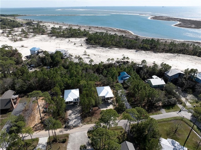 birds eye view of property with a water view and a view of the beach