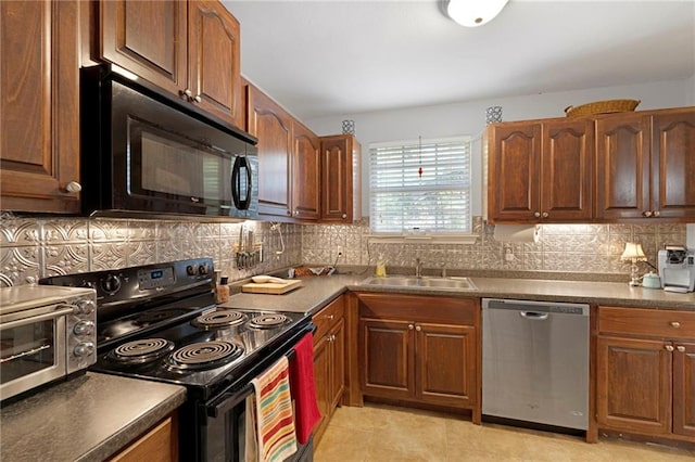 kitchen featuring light tile patterned flooring, sink, decorative backsplash, and black appliances