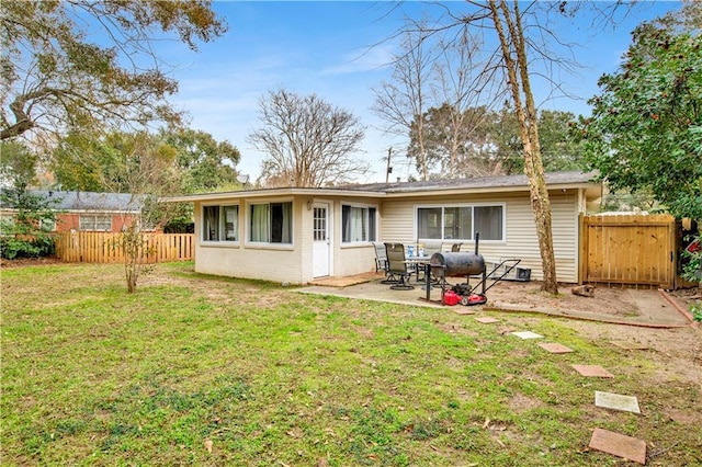 back of property featuring a yard and a patio