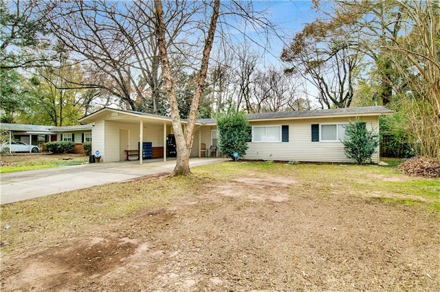 ranch-style home with a carport and a front yard