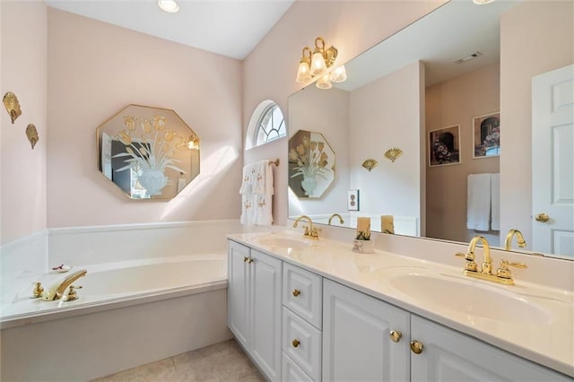 bathroom featuring vanity, tile patterned flooring, and a washtub