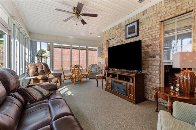 living room featuring ceiling fan, a fireplace, and carpet floors