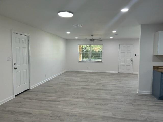 unfurnished living room with light hardwood / wood-style flooring and ceiling fan