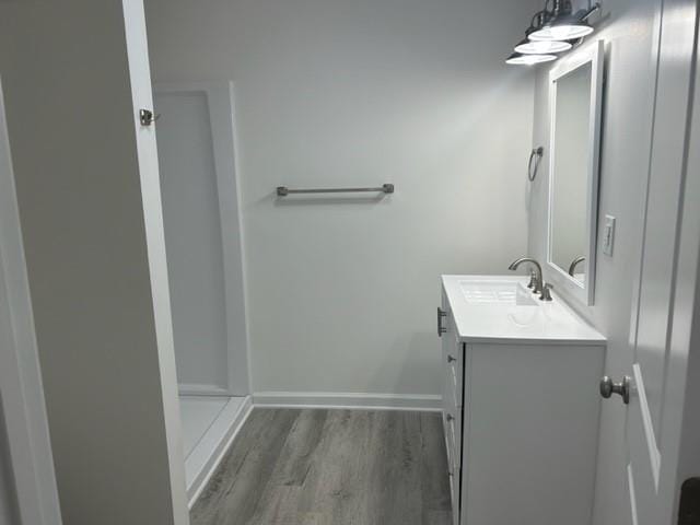 bathroom with vanity and hardwood / wood-style flooring