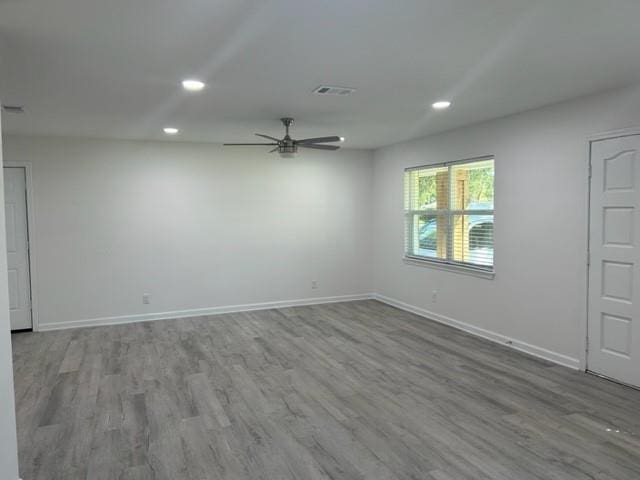 empty room featuring wood-type flooring and ceiling fan