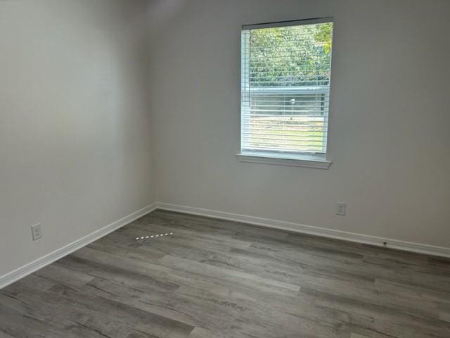 spare room with hardwood / wood-style flooring