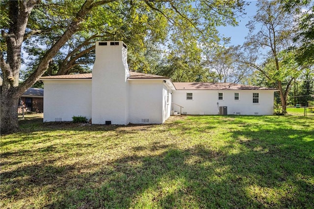 rear view of house featuring a yard