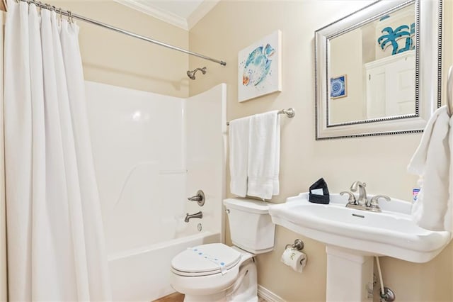 bathroom featuring crown molding, shower / bathtub combination with curtain, and toilet