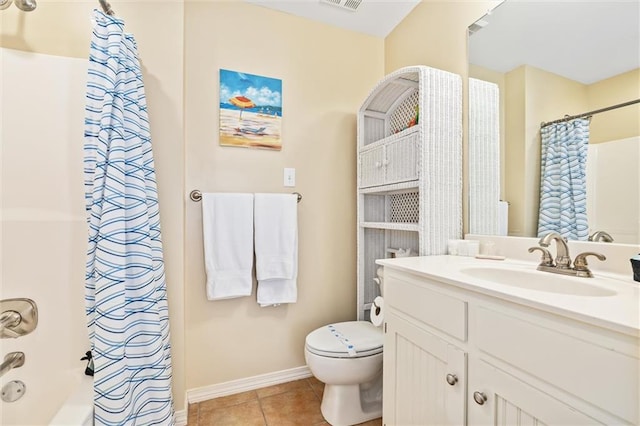 bathroom featuring tile patterned flooring, a shower with curtain, vanity, and toilet