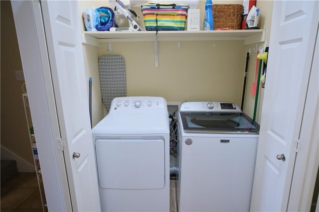 washroom with tile patterned floors and separate washer and dryer