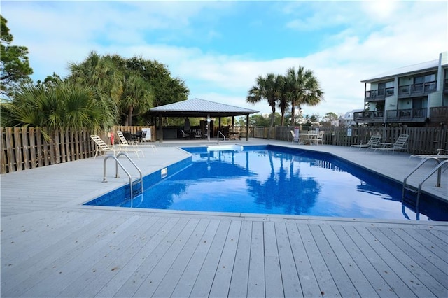 view of swimming pool with a gazebo and a deck