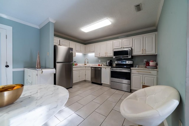 kitchen with white cabinets, appliances with stainless steel finishes, and a textured ceiling