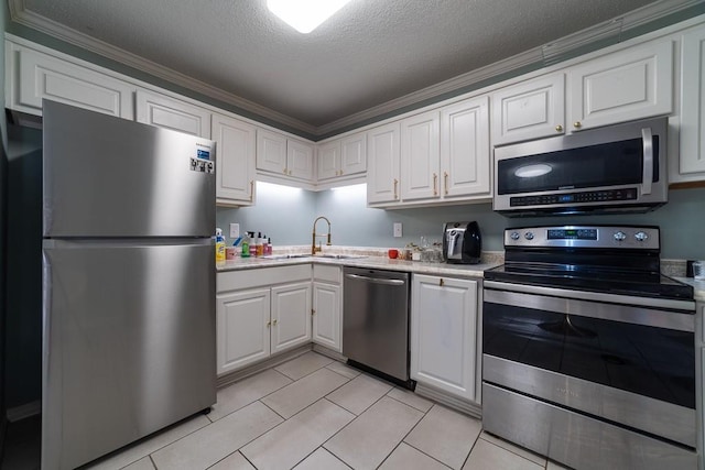 kitchen featuring white cabinetry, sink, stainless steel appliances, a textured ceiling, and light tile patterned flooring