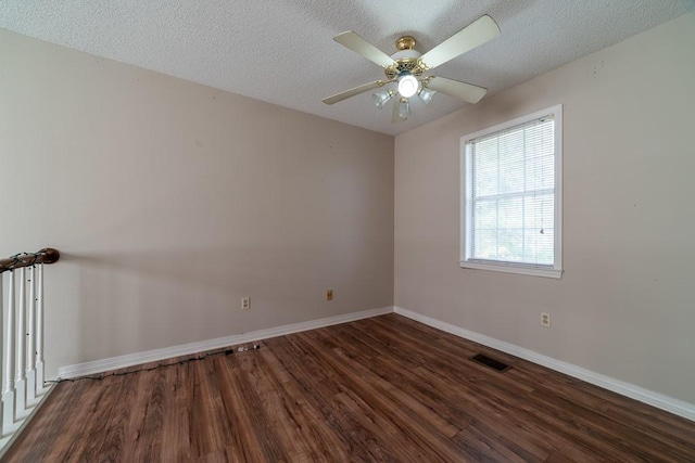 unfurnished room featuring ceiling fan, dark hardwood / wood-style flooring, and a textured ceiling