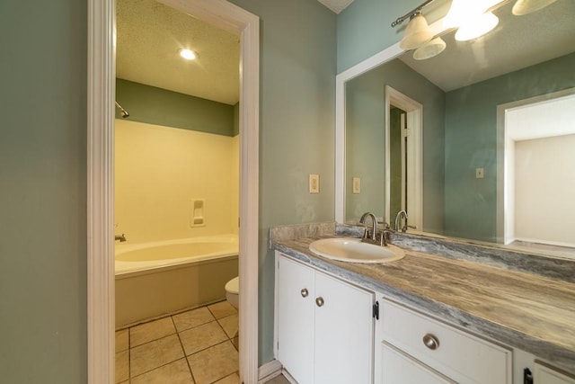 full bathroom with tile patterned flooring, a textured ceiling, vanity, and toilet