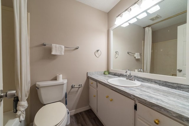 bathroom featuring vanity, hardwood / wood-style flooring, and toilet