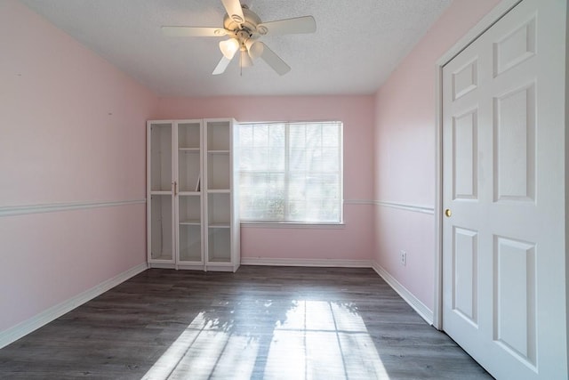 empty room featuring dark hardwood / wood-style flooring and ceiling fan