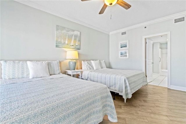 bedroom featuring connected bathroom, light hardwood / wood-style floors, ceiling fan, and crown molding