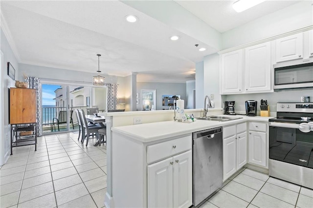 kitchen with kitchen peninsula, white cabinetry, stainless steel appliances, and decorative light fixtures